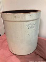 Side view of the beige crock showing the blue crown decal with the number 3 indicating size.