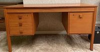 Front view of desk showing overall structure, drawers on left and right