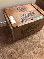 Wooden John Labatt Classic crate with hinged lid closed showing Labatt branding on top and side.