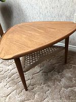 Triangular top view showing wood grain pattern and tapered legs