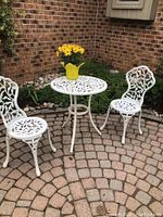 Overview of entire set—table and two chairs on brick patio