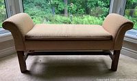 Front view of pink pastel roll arm two-seater bench showing cushioned seat and wooden legs