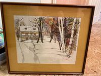 Front view of framed winter painting featuring a century home with snow and trees