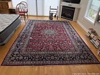 Full room view of the rug laid flat showing overall design and condition