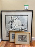 Overall view of the three paintings including the large Asian floral and two smaller nautical paintings