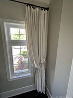 Curtain panel hung at window showing drape and size