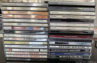Stack of 32 alternative music CDs from the 1980s showing titles and labels on case spines.