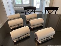 6 white DiscGear disc storage cases on a black table, all closed.