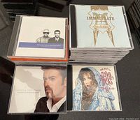 Image showing stacks of CDs featuring Pet Shop Boys discography, Madonna Immaculate Collection, George Michael's Greatest Hits, and Stevie Nicks' Greatest Hits.