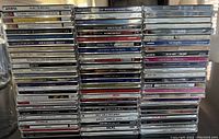 Photo showing the full set of 76 CDs stacked in vertical stacks with titles visible, showing variety of artists from 1990s Pop and Rock genres.
