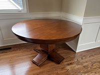 Front view of table positioned in room showing full top and base