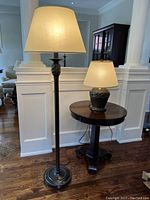 Floor lamp and table lamp side by side in room