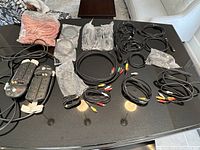 Photo showing all items including surge protector power bars, various cables spread out on a table.