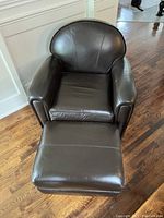 Front view of leather chair with ottoman in front
