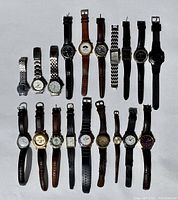 Top-down photo showing all 19 wristwatches laid out in 2 rows, various strap styles and brands visible.