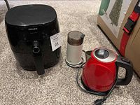 Philips air fryer, Chef's Choice kettle and Braun coffee grinder on carpeted floor