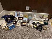 Overall view of 19 jewelry pieces arranged on carpet