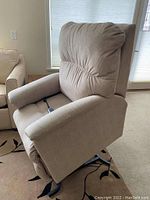 Front-right angle view of the chair upright showing overall shape, upholstery and metal lift base