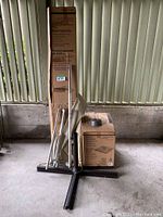 Overview of folded umbrella parts, cross base stand and boxed base blocks