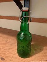 Close-up of green embossed Grolsch beer bottle with swing-top ceramic cap