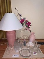 Full lot visible on table including lamp, candle holders, vases, glass decor, and shell.