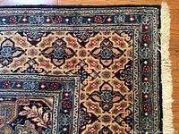 Close-up of corner showing cream fringe and navy border pattern