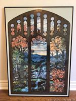 Full view of framed stained glass style autumn landscape artwork with arched top and black frame