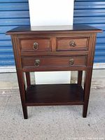 Front view of hall table showing three drawers and lower shelf