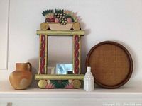 Photo showing the full set with mirror, terra cotta jug, milk glass bottle, and wicker tray against white background