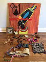 Wide shot showing all items in the lot arranged on the floor with the painting upright behind them