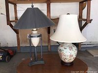 Photo showing two table lamps side by side with different designs and shades.