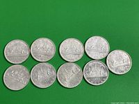 Nine 1966 Canadian silver dollar coins arranged in two rows on green background