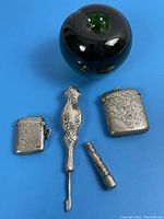Full group of four antique sterling silver items including 2 match holders, pin etui, and nail groomer with size reference apple