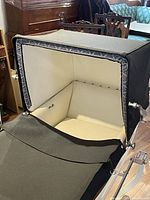 Interior view showing cream upholstery and black canopy open