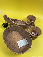 Oval birch bark basket, birch bark canoe, two small round baskets