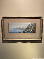 Framed watercolor painting of the European water scene, view showing entire piece mounted on wall.