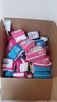 Box filled with several packs of feminine hygiene pads and panty liners.