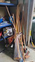 Full lot showing all garden tools and extension cord grouped together in garage corner