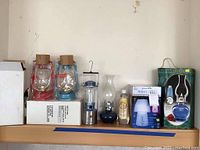 View of the full set with oil lamps and boxes on shelf