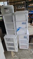 Several plastic drawer units stacked together, showing six individual units in various sizes with semi-transparent drawers and white frames.