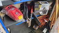 Overview of lot items on shelf including pressure washer, loppers, shop blower box, extension cord, paint can