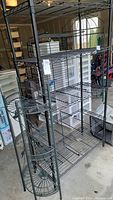 Wide view of the five-tier black metal wire shelving unit showing all shelves and corner posts