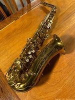 Overview of the full tenor saxophone laid on table