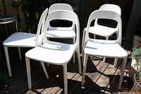 Five chairs arranged on wooden deck showing overall lot