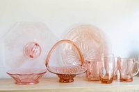 Full collection showing serving plates, basket, bowl, and four cups/mugs arranged on shelf