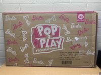 Box showing Barbie Pop 2 Play branding and product details.