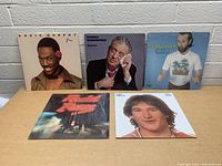 Photo showing the five comedy vinyl record covers grouped together: Eddie Murphy, Rodney Dangerfield, George Carlin in back row; Redd Foxx and Robin Williams in front row.