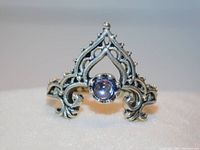 Front view of the V-shaped antiqued silver tone filigree ring with clear rhinestone center.