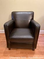 Front view of the Bradington Young dark brown leather club chair showing the full chair with seat cushion, wide armrests, and backrest.
