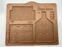 Full view of the rectangular stoneware cookie mold showing window, door, chimney and stone patterns with 'Stone house' text.